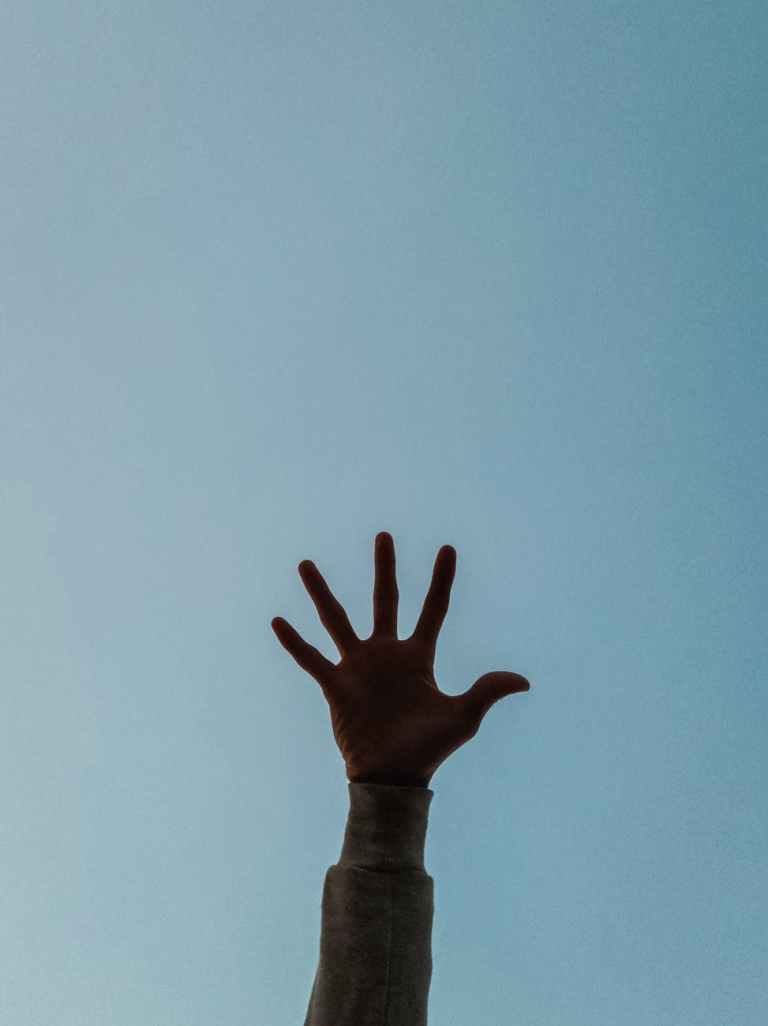 person s hand raised in the air